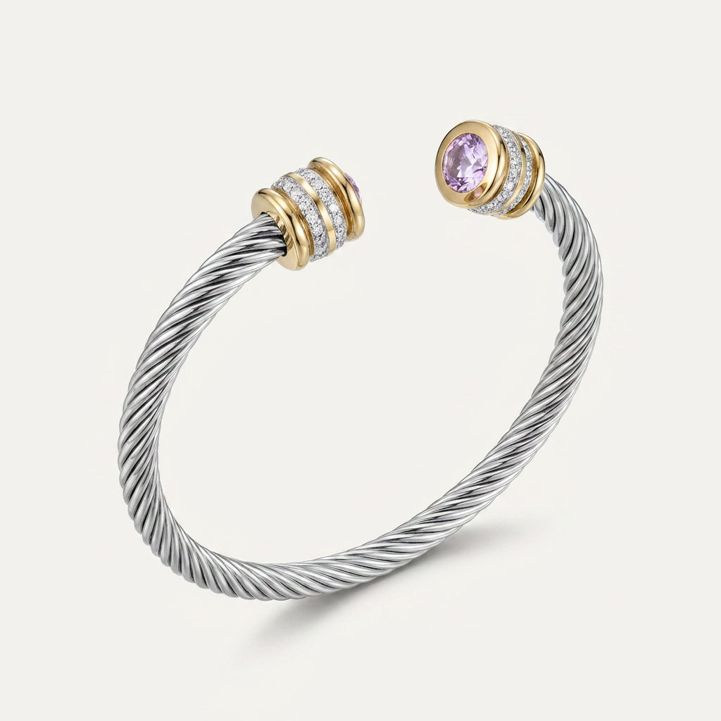Brazalete de puño abierto con cable trenzado de acero inoxidable plateado, extremos dorados con circonita cúbica rosa lila engastada.