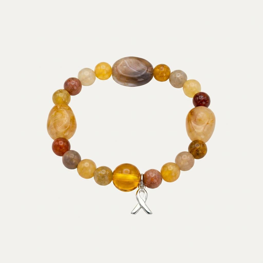 Pulsera Eclipse de piedras naturales semipreciosas en tonos dorados, ocres y marrones con colgante de lazo solidario en acero inoxidable, sobre fondo blanco.